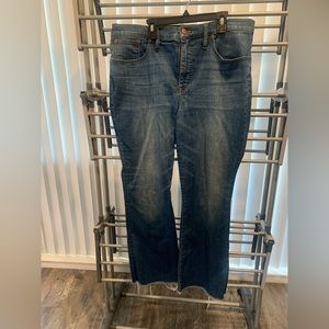 Madewell cali demi boot cut jean.  Raw hem with back stitching detail.